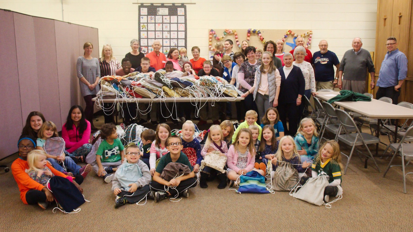 Sunday School students fill school bags with supplies before they are sent to Lutheran World Relief.